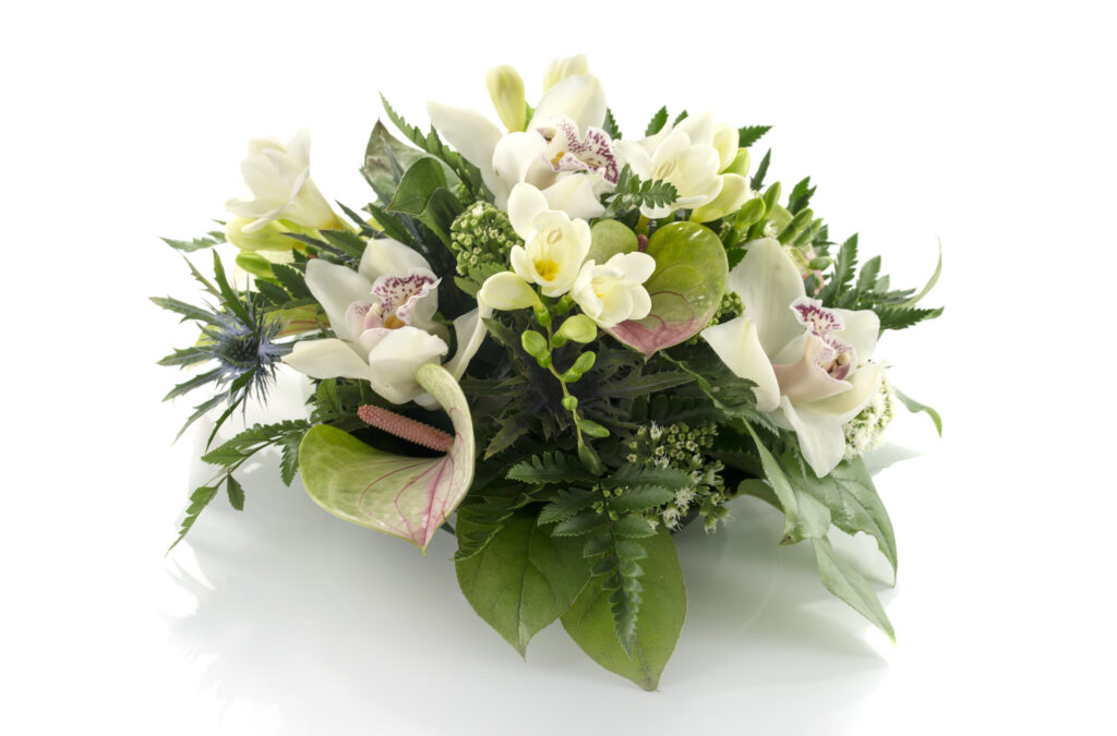 Flower arrangement with lilies, freesia, and arum.